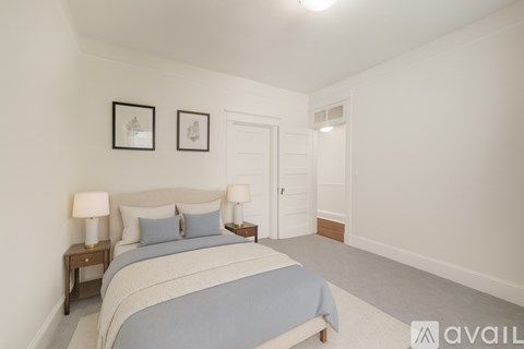 A bedroom with a bed, two nightstands, and two framed pictures on the wall.