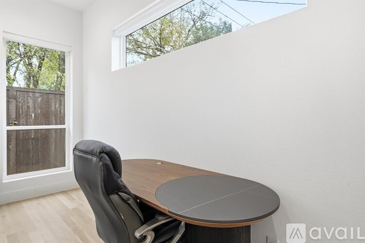 A room with a table and a chair in it.