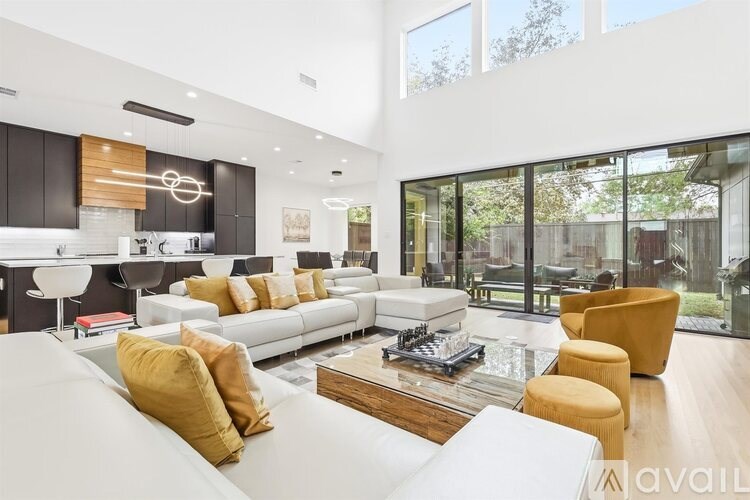 A modern living room with a white sofa and a coffee table.