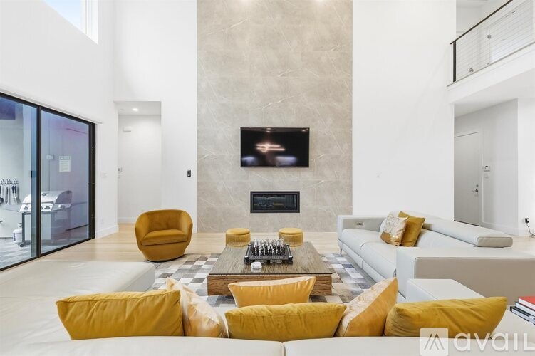 A modern living room with a fireplace and a television.