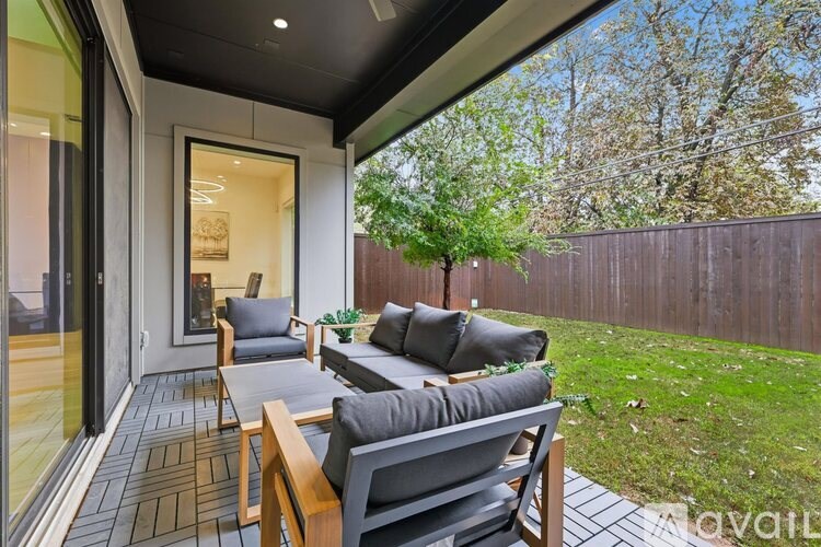 A patio with a couch, chairs, and a table is shown.