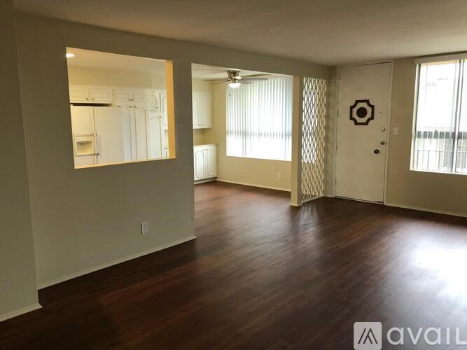 A room with wooden floors and a large mirror on the wall.