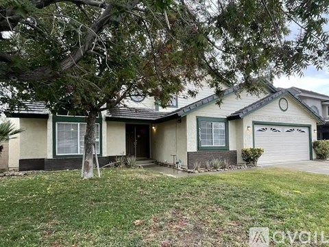 A house with a tree in front of it.