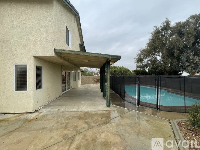 A house with a pool and a covered walkway.