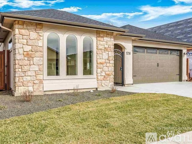 A house with a stone facade and a garage door.