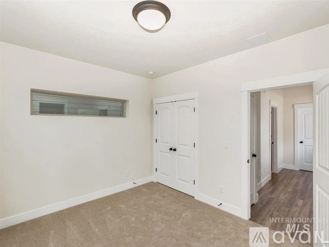 A room with white walls and a carpeted floor.