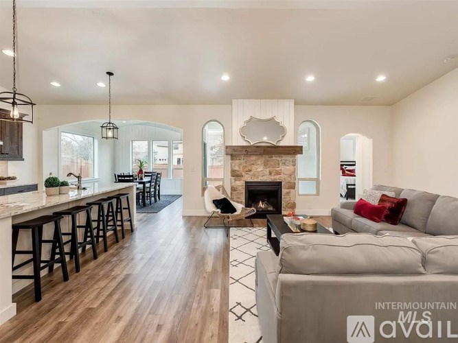 A modern living room with a fireplace and a bar area.