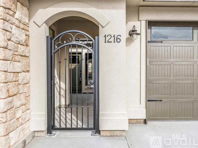 A black gate with the number 1216 on it.