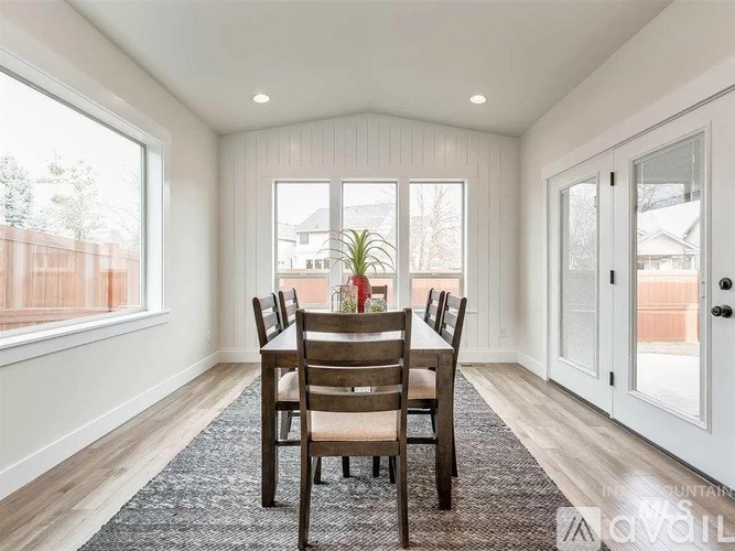 A dining room with a table and chairs.