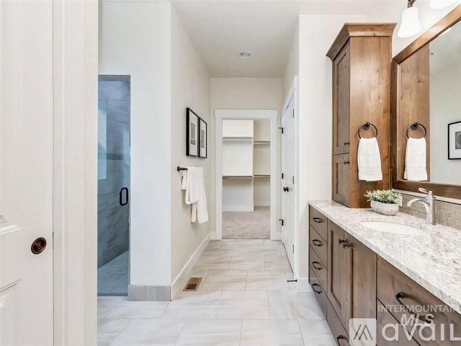 A bathroom with a white door and a marble counter.