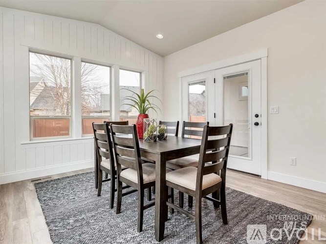 A dining room with a table and chairs.