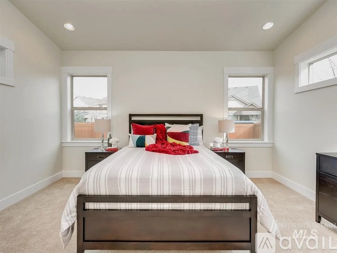 A bedroom with a large bed and a flat screen TV.