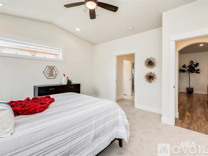 A bedroom with a bed, dresser, and mirror.