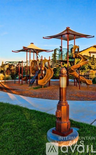 A playground with a slide and a sign that says "INTERMOUNTAIN AVAIL".