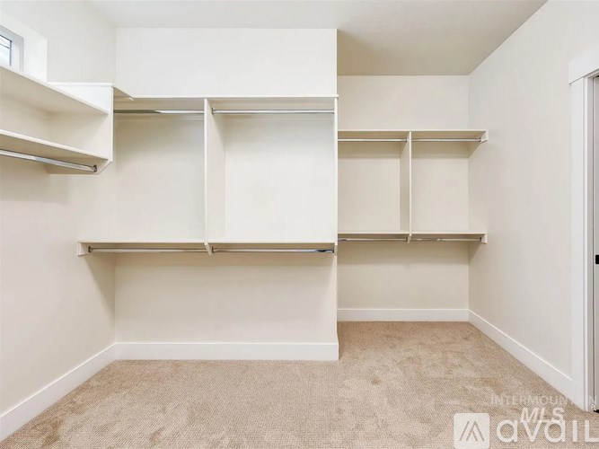 Empty room with white shelves and beige carpet.