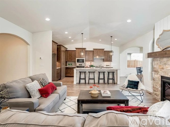 A living room with a grey couch and a coffee table.