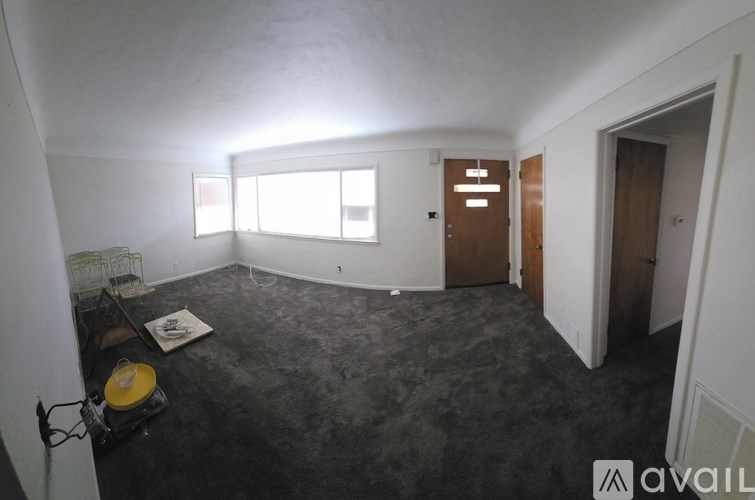 A room with a grey floor and white walls is shown.