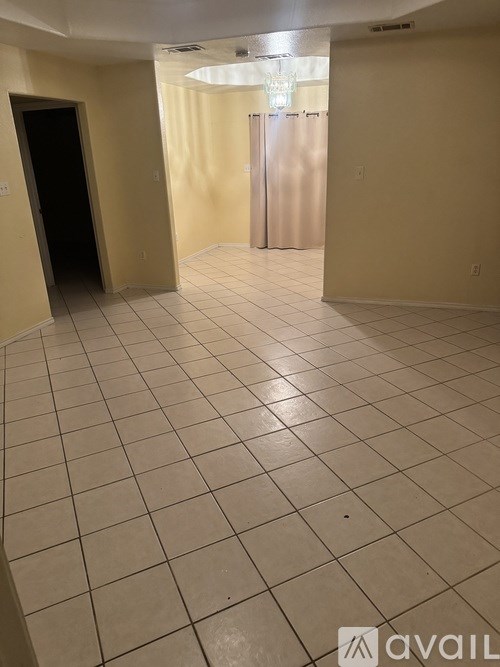 A room with a tiled floor and a door on the left.