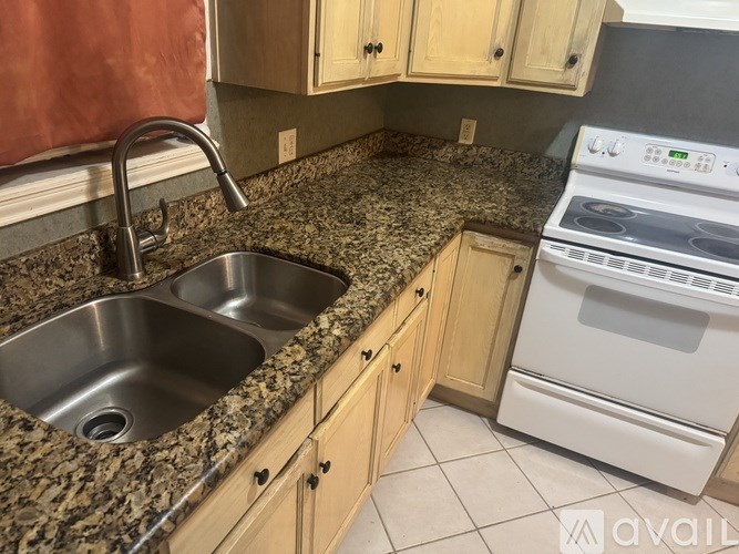 A kitchen with a sink and a stove.