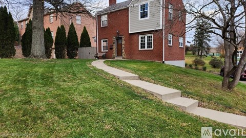 A red brick house with a white door and windows.