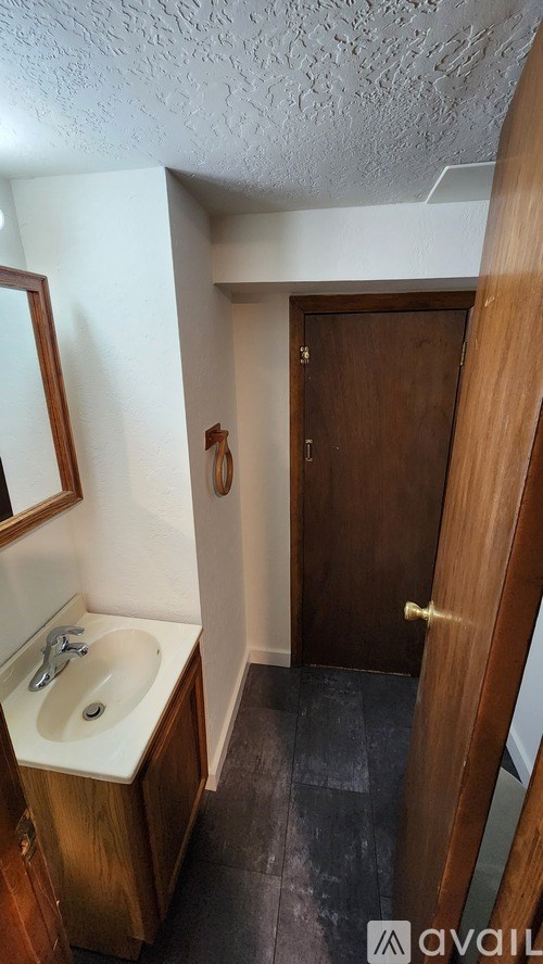A bathroom with a sink and mirror.