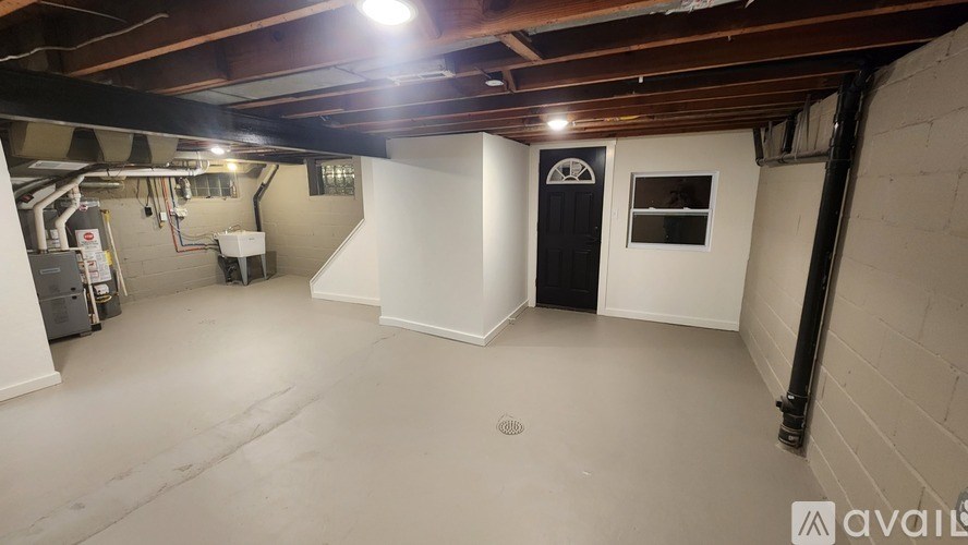 A spacious basement with a door and a window.