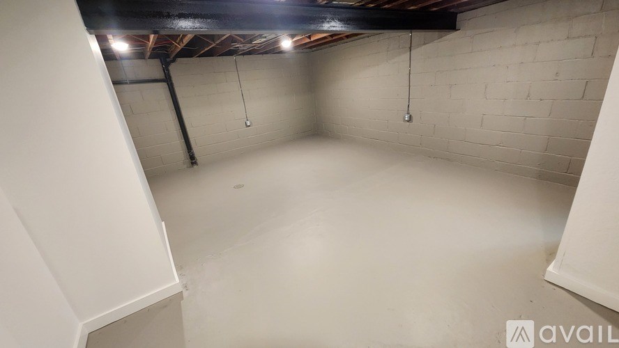 A spacious empty room with a white ceiling and walls.