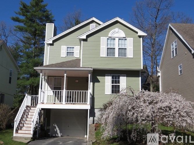 A two-story house with a balcony and a garage.