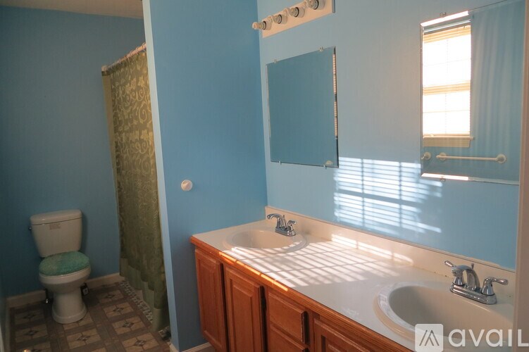 A bathroom with a toilet, sink, and shower.