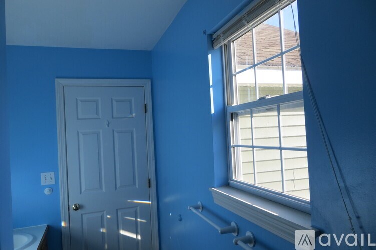 A white door is in a room with blue walls.