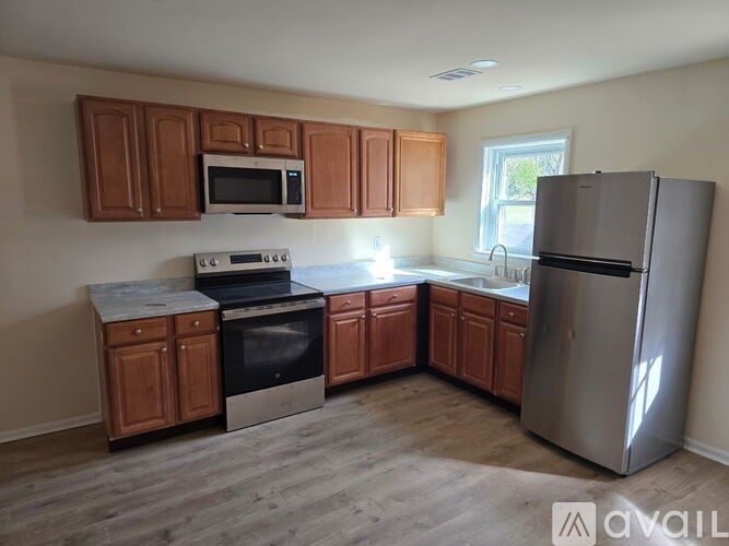 A kitchen with wooden cabinets and stainless steel appliances.