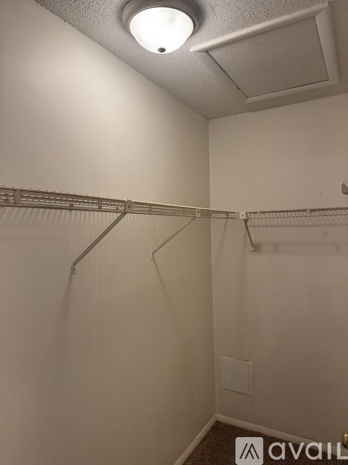 A small, empty room with a single light fixture on the ceiling.