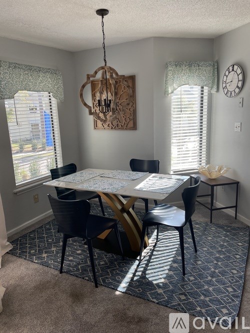 A dining room with a table set for four.