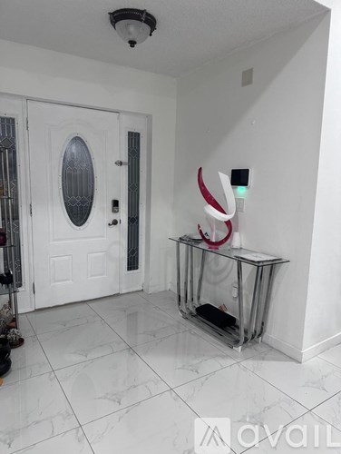 A white door with a glass window and a white wall.