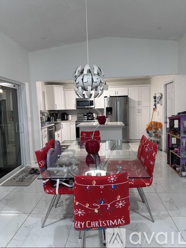 A modern kitchen with a Christmas themed table set.