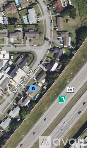 A bird's eye view of a residential area with a road passing through it.