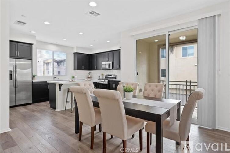A modern kitchen with a dining table and chairs.