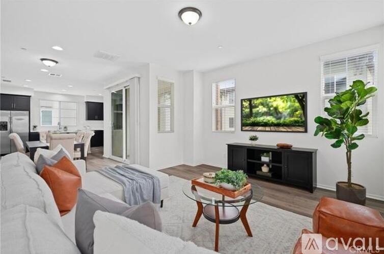 A living room with a grey couch and a wooden coffee table.