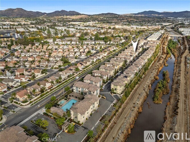 A bird's eye view of a residential area with a river running through it.