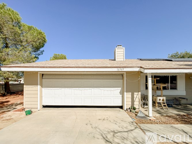 A garage with a white door and a chimney on the roof.