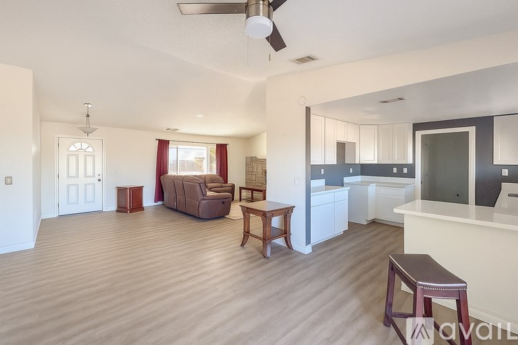 A living room with a couch, chair, and table.