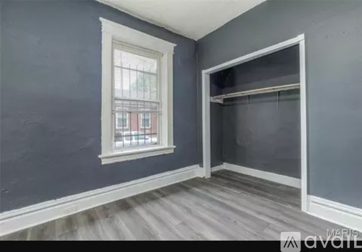 A room with a window and a closet.