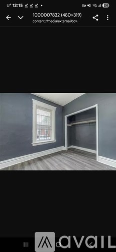 A room with grey walls and a window.