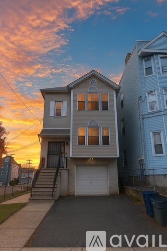 A two-story house with a garage is available for rent.