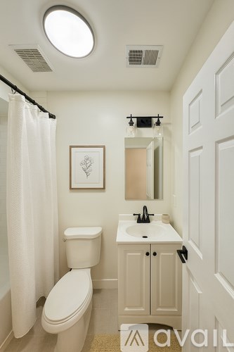 A white toilet sits next to a sink in a bathroom.