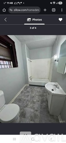 A bathroom with a toilet, sink, and bathtub.