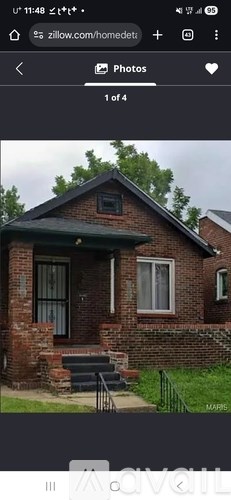 A brick house with a green roof and a white door.