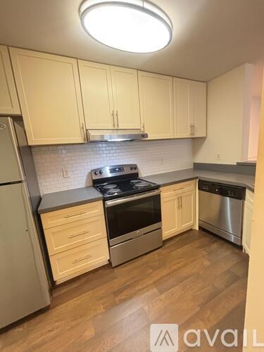 A kitchen with wooden cabinets and stainless steel appliances.