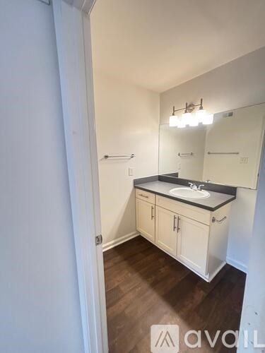 A bathroom with a sink and a mirror.