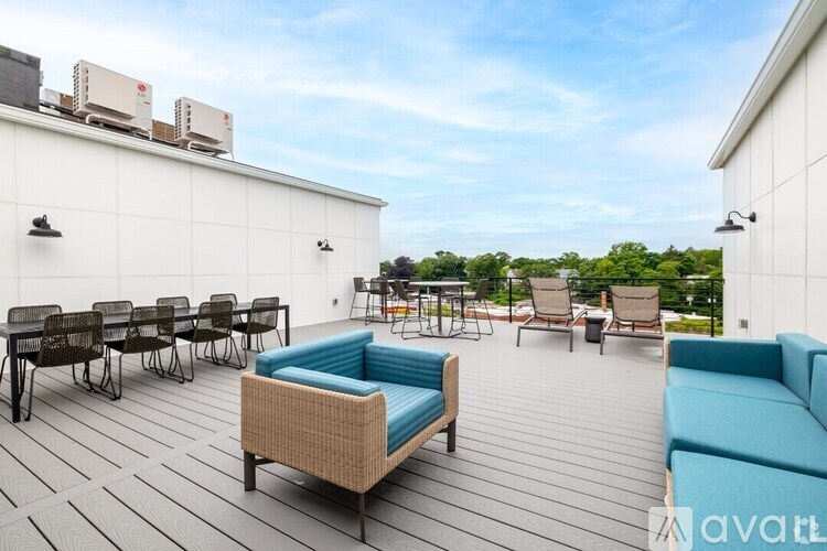 A patio with a blue couch and chairs.